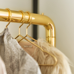 Chubby clothing rack with hangers brass
